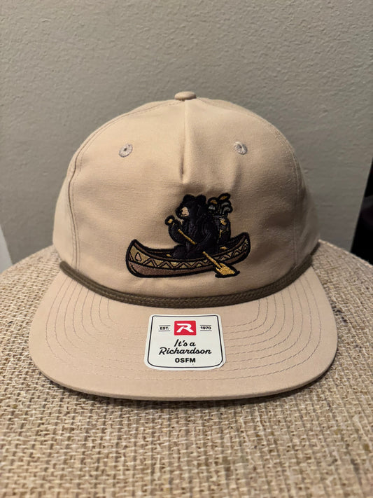 Grizzly Greens tan rope golf hat front view with bear canoe embroidery